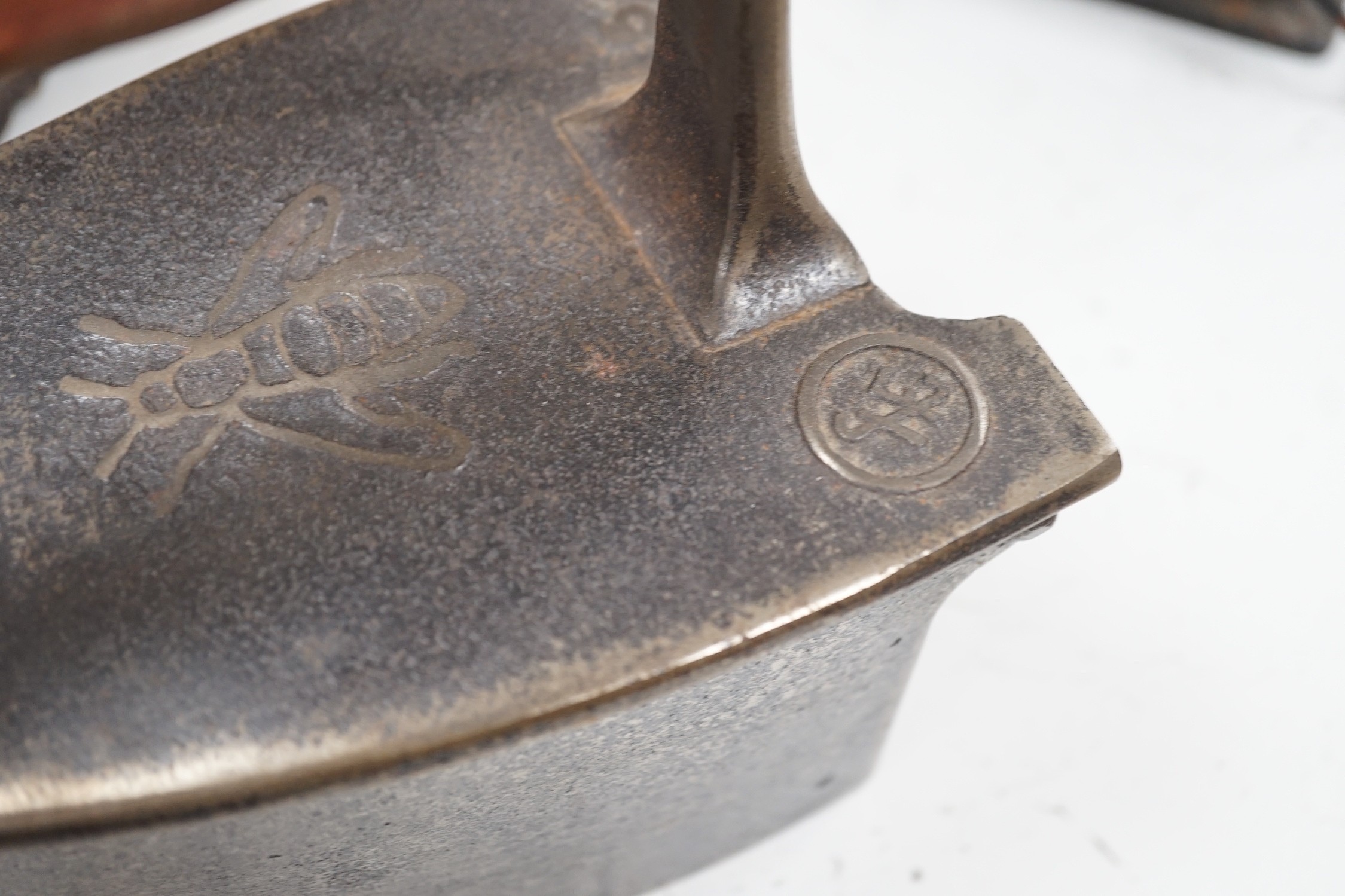 Four French coal/slug irons, three trivets and a stripped pine glazed cabinet, 37cm high